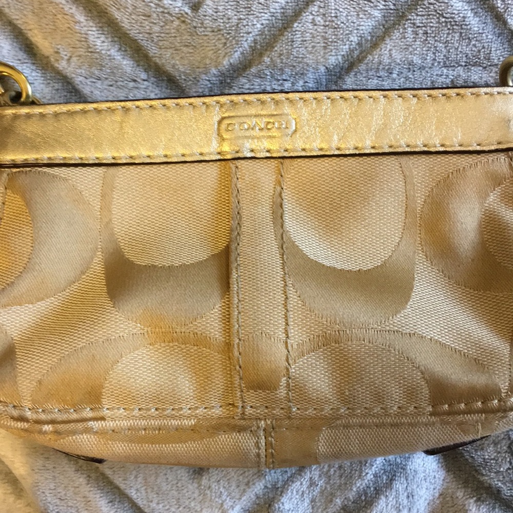 Gold and taupe Coach wristlet